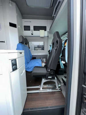 Wohnmobil-Innenraum mit nachgerüstetem Sitzplatz neben der Küchenzeile